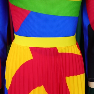 Detail of high waist contrast pleated skirt showing colorful geometric patchwork and textures