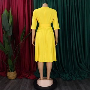 Back view of yellow pleated midi dress featuring three-quarter sleeves and matching waist belt