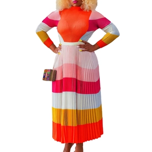 Detail of colorful pleated skirt with rainbow stripes and textured knit bodice fabric
