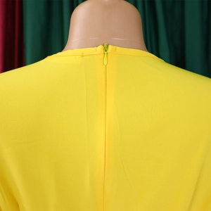 Detail of invisible back zipper on a bright yellow V-neck pleated African dress