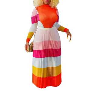 Detailed view of the pleated texture and vibrant color-block pattern on the long-sleeve dress