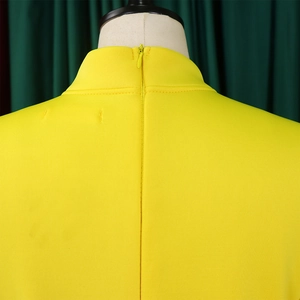 Detail of high collar neck with invisible back zipper on yellow formal dress