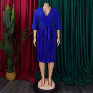 Detail of royal blue pleated midi dress with V-neckline and waist tie on mannequin