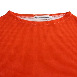 Detail of orange waffle knit collar with high-quality stitching and neck label