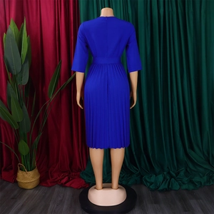 Rear view detail of royal blue long sleeve pleated dress with matching waist belt