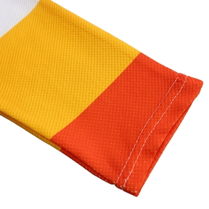 Close-up of mesh knit sleeve with orange and yellow color blocking and double stitching