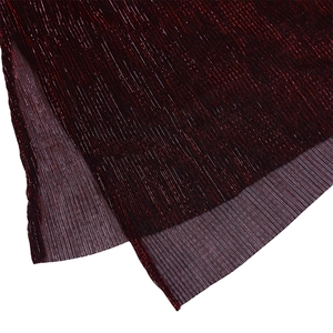 Close-up of dark red pleated fabric with metallic luster and fine vertical textures