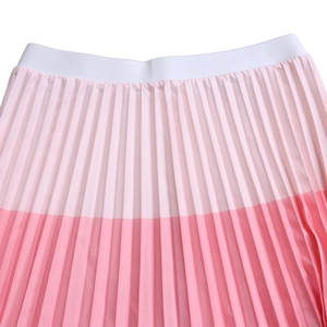 Detail of high-elasticity white waistband on pleated pink contrast two-piece skirt