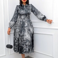 Detail of elegant black and white marble print maxi dress with tie neck and long sleeves