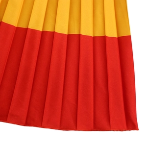 Detailed view of yellow and red pleated fabric texture with precise hem stitching