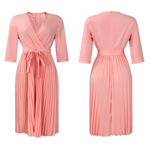Detail view of pink V-neck dress featuring pleated hem and waist tie closure