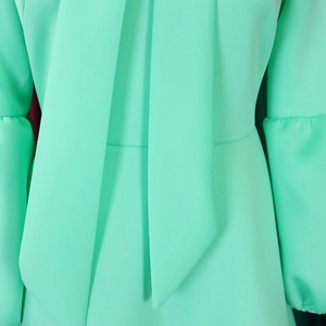 Detail of mint green lantern sleeves and pussy-bow neck on a lightweight dress