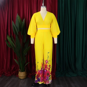 Detail of yellow V-neck lantern sleeve top and floral print wide-leg pants on mannequin