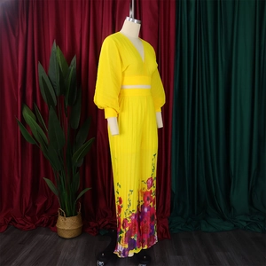 Detail of yellow V-neck pleated top with lantern sleeves and floral print wide leg pants