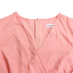 Detail of elegant V-neckline and hidden back zipper on this light pink African dress