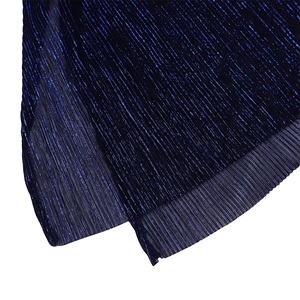Macro detail of navy blue pleated fabric with metallic sheen and vertical textures