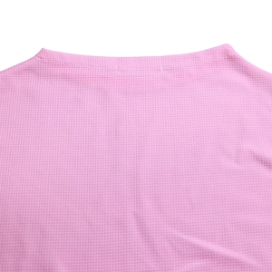 Close-up of pink knit fabric texture showing the straight neckline and soft waffle weave