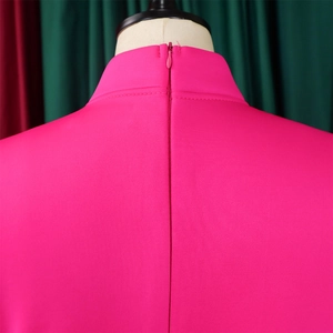 Detailed close-up of the high collar and invisible zipper on the rose red formal dress