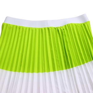 Detail of high-waist pleated skirt with green and white color blocking and elastic waistband