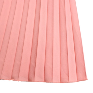 Detail view of pink pleated fabric showing delicate stitching and high-quality texture