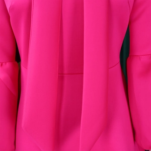 Detail of rose pink dress featuring elegant wide tie straps and pleated puff sleeve texture