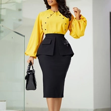 Detail of yellow long sleeve blouse with black buttons and high waist skirt ensemble
