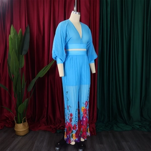 Detailed close-up of V-neck chiffon top and floral print wide-leg pants set in bright blue