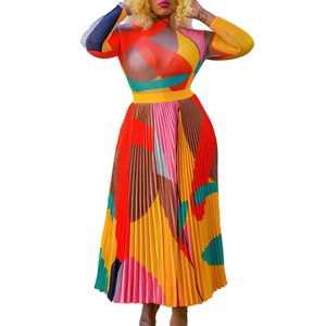 Detail of multi-color pleated long sleeve top with bold geometric print and texture