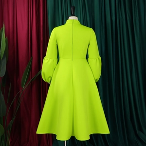 Back view of neon green puff sleeve gown with high neck and wide flared A-line skirt
