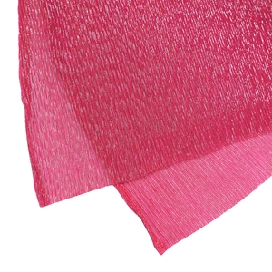Macro detail of sparkly fuchsia fabric with metallic silver threads and vertical pleats