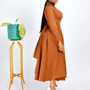 Detail of high neck beaded collar on a caramel long sleeve flared dress