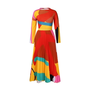 Close-up of vibrant abstract geometric print and fine pleats on the long-sleeve dress