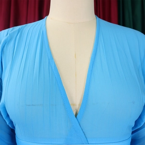 Close-up of sky blue chiffon V-neck top with pleated texture and light fabric detail