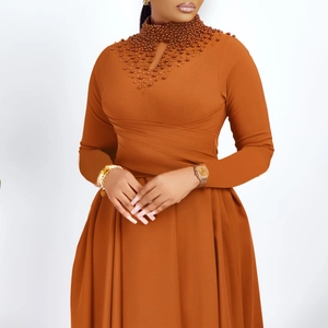 Detail of high neck orange dress with elegant beadwork and teardrop cut-out