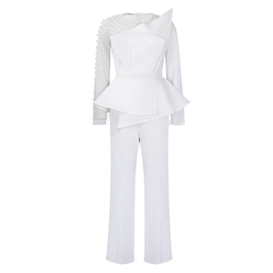 Detail of white jumpsuit with mesh sleeve, pearls, and sculptural asymmetric ruffles