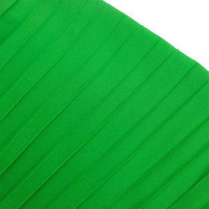 Detailed macro view of the pleated emerald green fabric with elegant silk-like texture