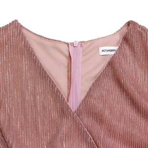 Detail of pink metallic V-neck dress with shimmer fabric texture and METAMORPH label
