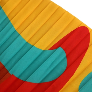 Detailed close-up of vibrant pleated fabric with abstract colorful geometric patterns