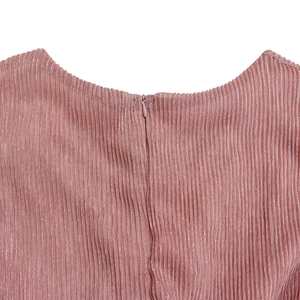 Detail of pink pleated fabric dress featuring a hidden zipper and subtle shimmering texture