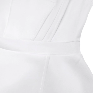 Close-up of white jumpsuit featuring intricate pleated waist and fine stitching details