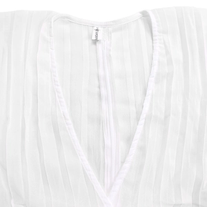 Detailed close-up of V-neckline with zipper and pleated texture on white chiffon top
