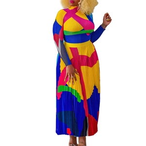 Detail of color-block pleated maxi skirt and long sleeve top with geometric prints