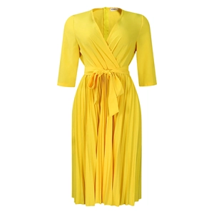 Detail of elegant V-neck pleated yellow dress with waist tie and wrap-style bodice