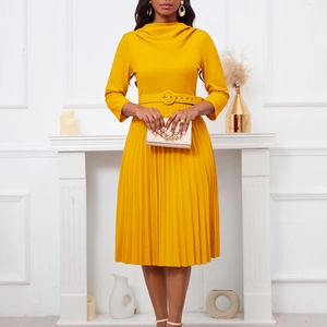 Detail of elegant yellow pleated dress featuring a high waist belt and stylish cowl neck