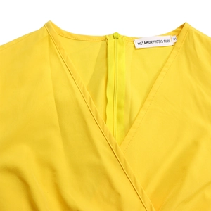 Detail view of yellow V-neck dress featuring crossover design and invisible back zipper