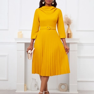 Detail of elegant yellow pleated midi dress featuring waist belt and high neckline