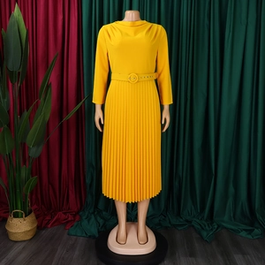 Detail of elegant yellow pleated dress with matching belt and long sleeves for women