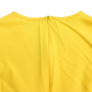 Detail of elegant yellow dress featuring a hidden back zipper and high-quality fabric texture