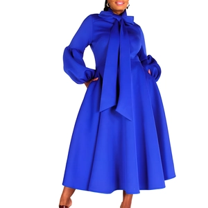 Detail of royal blue puff sleeve dress with a large bow neckline and A-line silhouette