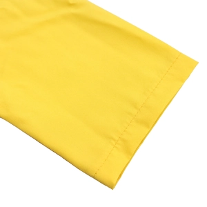 Detail of yellow long sleeve dress showing fine stitching and smooth fabric texture